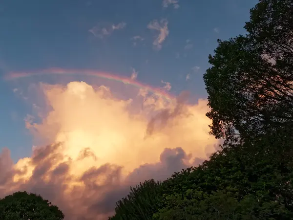 Rainbow Over Clouds in Blue Sky — Stock Photo, Image