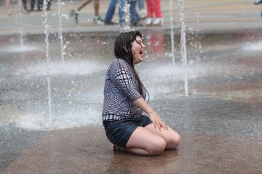 Kharkiv, Ukrayna - 1 Haziran 2015: Çeşme oynayan genç kız.