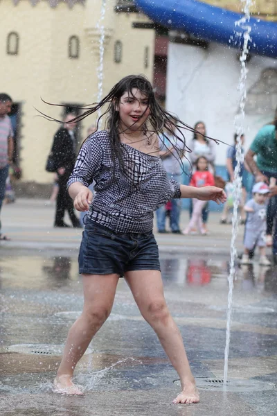 Kharkiv, Ukrayna - 1 Haziran 2015: Çeşme oynayan genç kız.