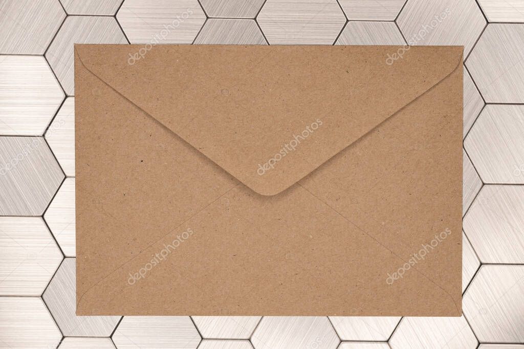 Brown craft envelope on steel background. Mail envelope or letter.