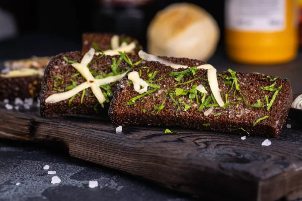 Black bread toasts with garlic and salt. Black garlic bread snack.