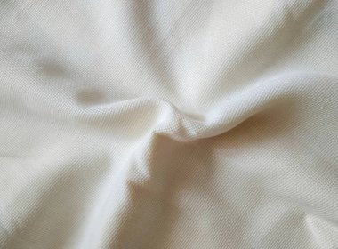 Süt beyazı buruşuk tuval yakın çekim. Kumaş dokusu arkaplanı