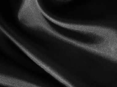 Parlak, siyah, buruşuk kumaş arka plan. Sıvı dalgalı şekil.  