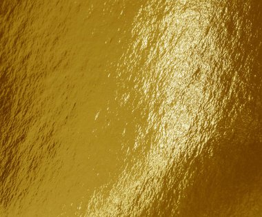 Vurguları ve düzensiz dokusu olan altın folyo arkaplan