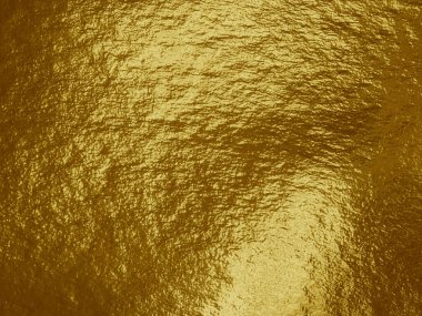 Vurguları ve düzensiz dokusu olan altın folyo arkaplan