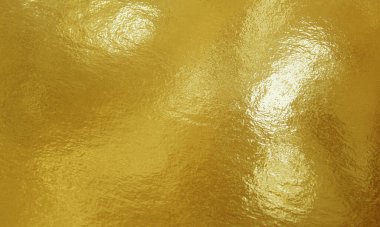 Vurguları ve düz olmayan yüzeyi olan altın folyo dokusu