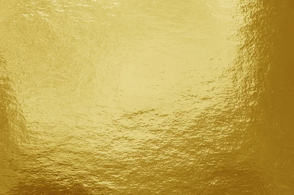 Gold foil background with highlights and uneven texture