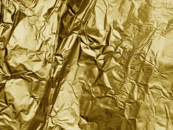 Gold metallic crumpled foil texture background