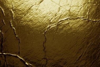 Grunge altın folyo dokusu çatlaklar ve çizikler ile arka plan