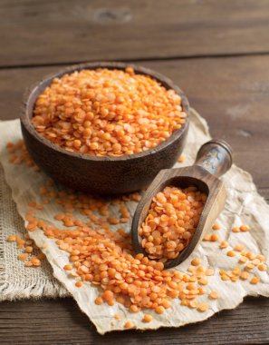 Red lentils in a bowl with a spoon clipart