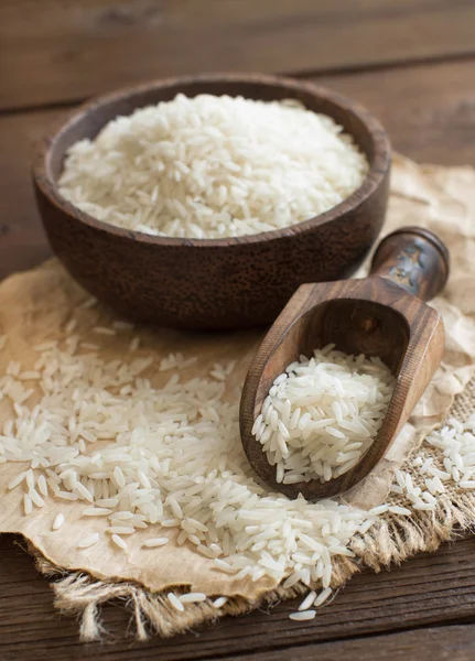 Pile of Basmati rice in a bowl with a spoon — Stock Photo, Image