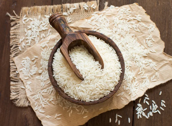 Pile of Basmati rice in a bowl with a spoon — Stock Photo, Image