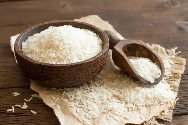 Pile of Basmati rice in a bowl with a spoon — Stock Photo, Image