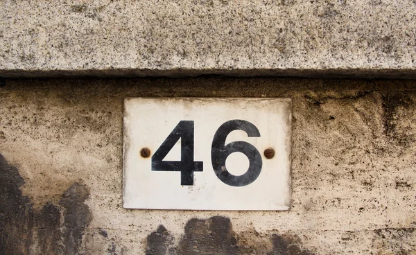 Номер сорок шість на сірій кам'яній стіні — стокове фото