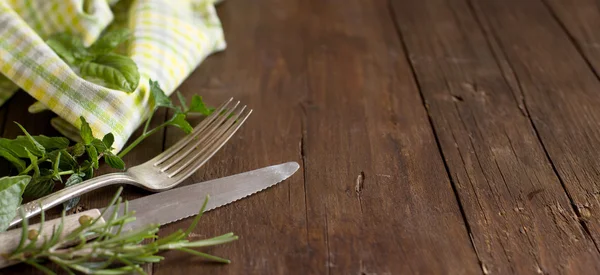 Vintage fork and knife with herbs and napkin — Stock Photo, Image