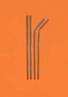 Ornage arka planında yeniden kullanılabilir paslanmaz çelik çubuklar. Çevre dostu yaşam tarzı kavramı