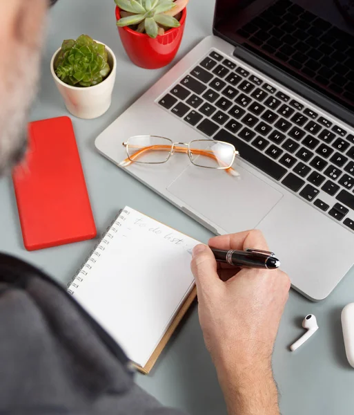 Man Writing List Laptop Grey Office Desk Close — Stock Photo, Image