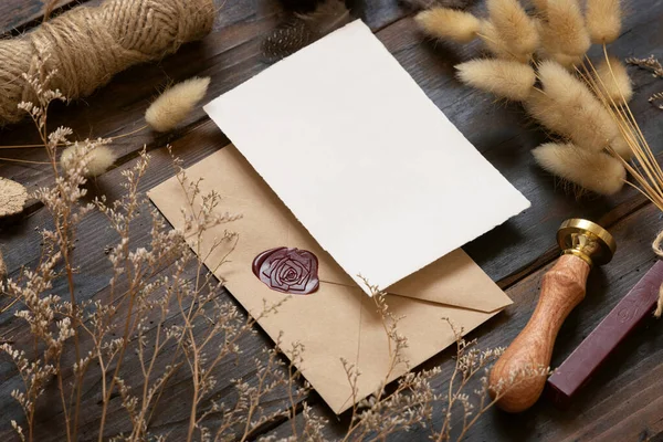 Blanco Papieren Kaart Verzegelde Envelop Houten Tafel Met Gedroogde Planten — Stockfoto