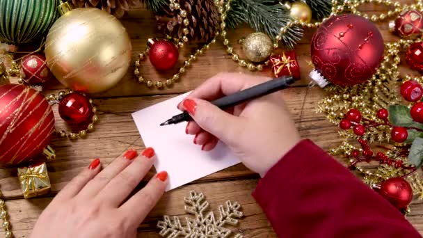 Woman Hand Writing Greeting Card Wooden Table Christmas Decorations Close — Stock Video