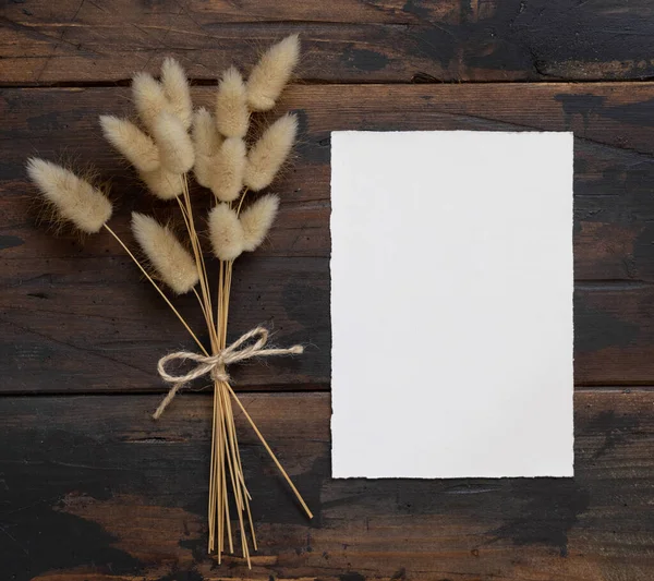 Tarjeta Papel Blanco Blanco Sobre Mesa Madera Marrón Con Flores —  Fotos de Stock