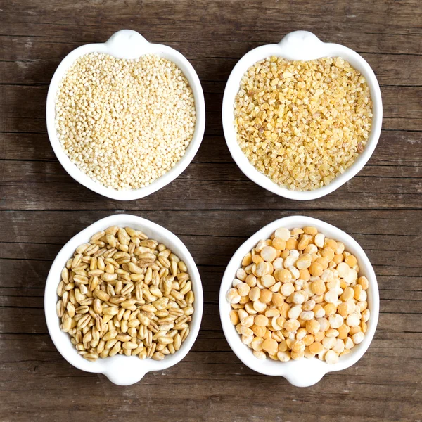 Millet, spelt, bulgur and yellow peas — Stock Photo, Image