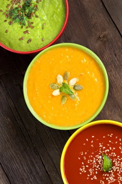 Three fresh soups on a wooden table — Stock Image Three fresh soups on a wooden table Stock Image