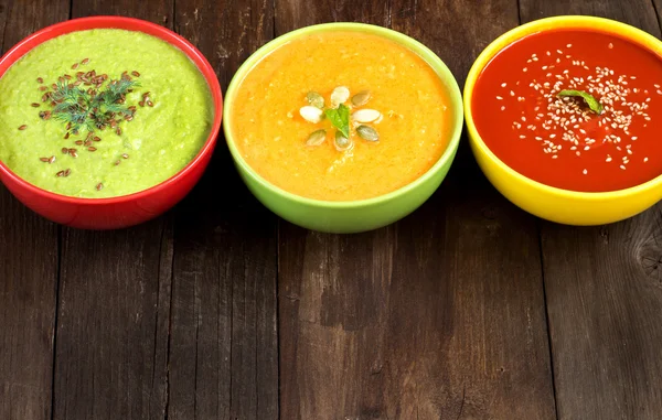 Three fresh soups on a wooden table — Stock Image Three fresh soups on a wooden table Stock Image