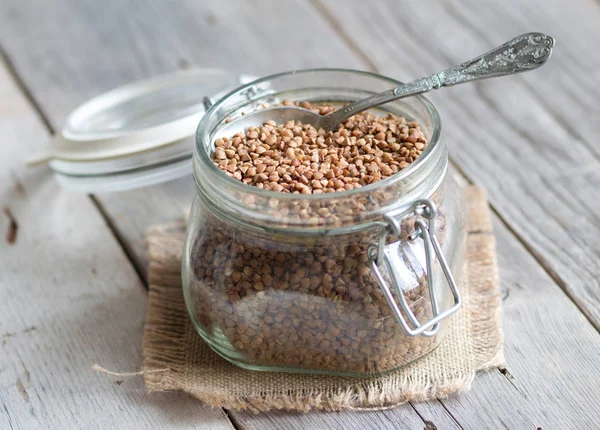 Buckwheat in a glass jar — Stock Photo, Image