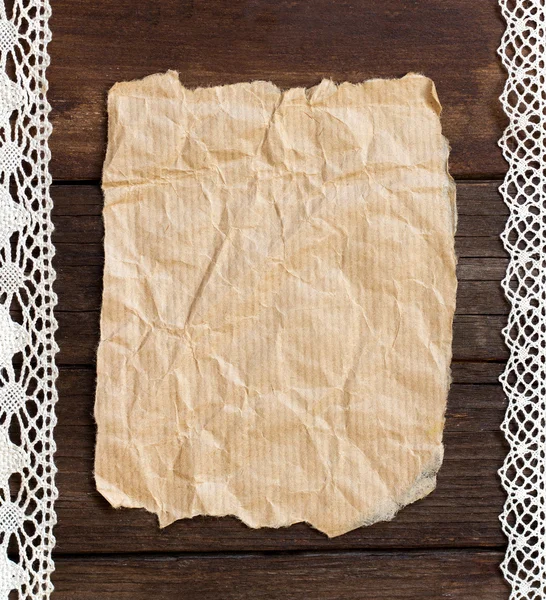 Old paper on the wood background — Stock Photo, Image