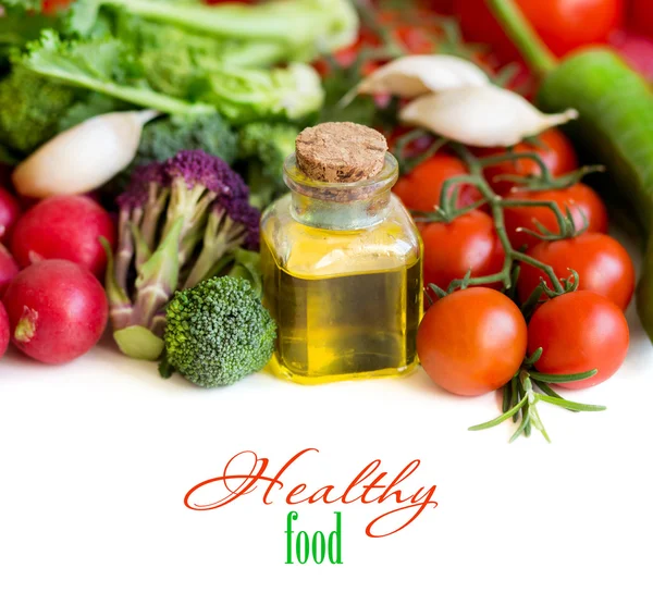 Vegetables and bottle of olive oil close up — Stock Photo, Image