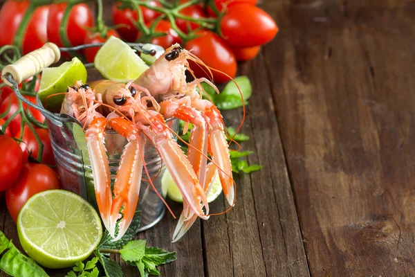 Raw langoustine in a bucket with vegetables — Stock Photo, Image