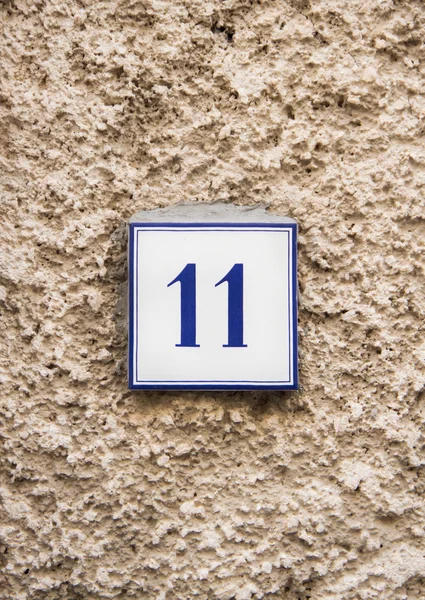 Number eleven on the stone wall — Stockfoto