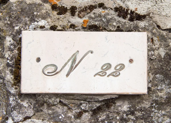 Number twenty two on the grey stone wall — Stock Photo, Image