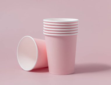 Tek kullanımlık pembe kağıt bardaklar yakın çekim izole edilmiş, reklam alanı olan bir model. Boş karton kahve fincanları. Kapağı olmayan çevre dostu tek kullanımlık konteynırlar, plastikten ayrıştırılabilir materyal yok.