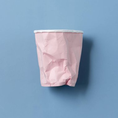 Açık mavi üst manzaralı tek kullanımlık pembe kağıt bardak, kopyalama alanı. Tüketim kavramı 