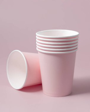 Tek kullanımlık pembe kağıt bardaklar yakın çekim izole edilmiş, reklam alanı olan bir model. Boş karton kahve fincanları. Kapağı olmayan çevre dostu tek kullanımlık konteynırlar, plastikten ayrıştırılabilir materyal yok.