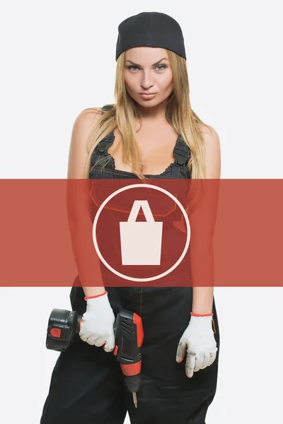 Sexy female holding a cordless screwdriver. Repair icon in the background woman. purchases — Φωτογραφία Αρχείου
