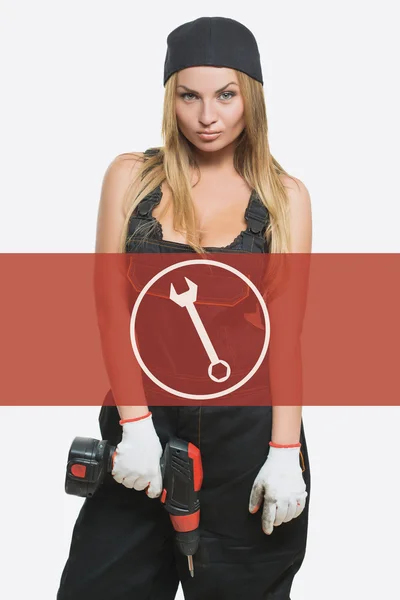 Sexy female holding a cordless screwdriver. Repair icon in the background woman. — Φωτογραφία Αρχείου