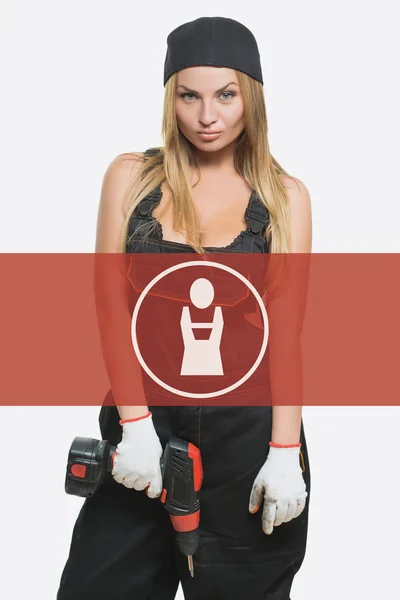 Sexy female holding a cordless screwdriver. Repair icon in the background woman. — Zdjęcie stockowe