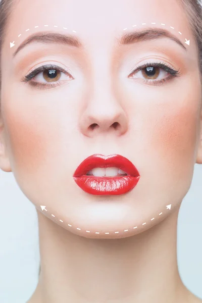 Portrait of young woman with arrows on her face — Stock Photo, Image