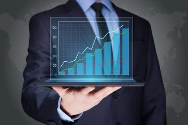 businessman hold tablet with graph on high technology
