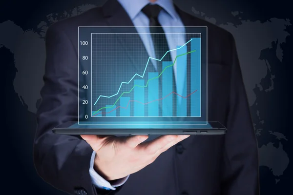 Businessman hold tablet with graph on high technology — Stockfoto