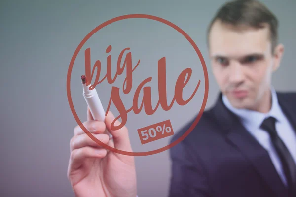 BIG SALE - Businessman writing text on a transparent board — Stockfoto