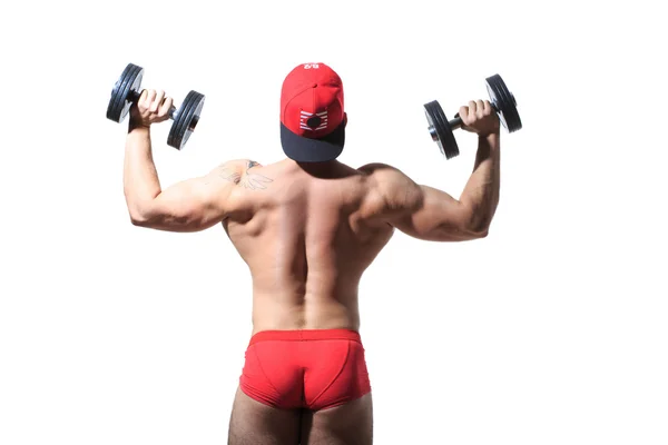 Muscular culturista chico haciendo ejercicios con pesas aisladas sobre blanco. Atrás — Foto de Stock