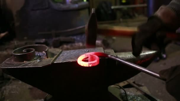 Blacksmith working on metal on anvil at forge. — Stock Video