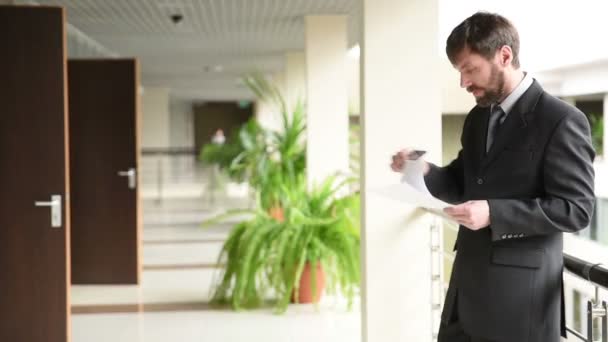 Mature Businessman Working With Papers And Cellphone At Workplace — Stock Video