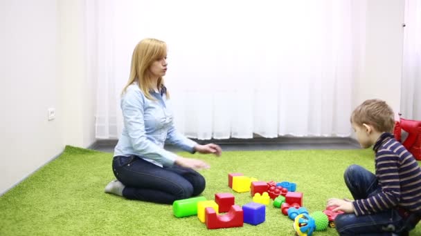 Young woman with baby boy during plaing. — Αρχείο Βίντεο