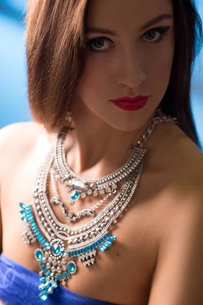 Necklace on the neck. ruby and emerald — Stock Photo, Image