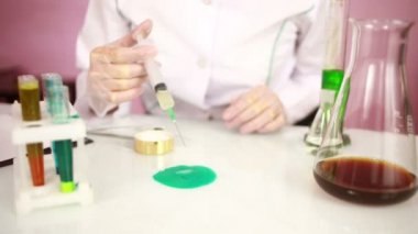 Kadın kimyacı test tüpleri kimyasallar ile karşılaştırma. koruyucu gözlük