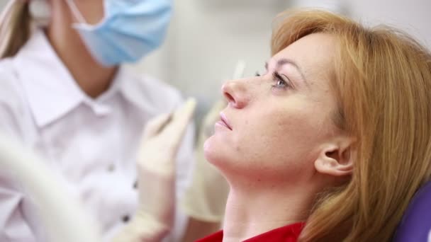 Woman receiving dental inspection from dentist — Stockvideo